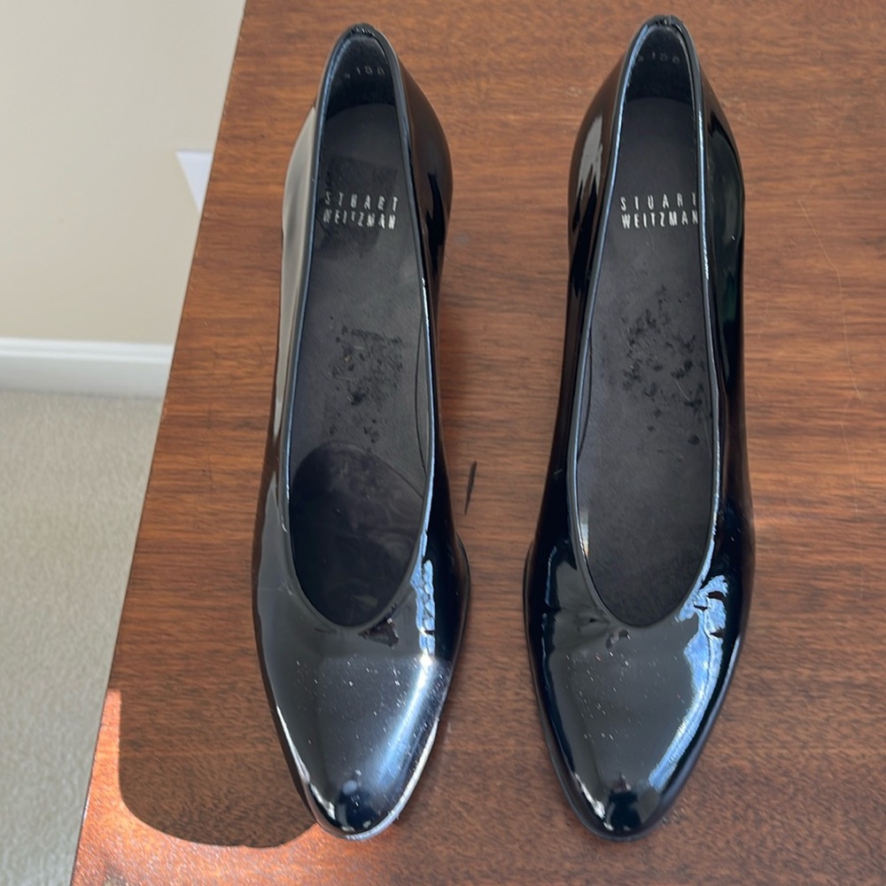Stuart Weitzman black patent pumps.